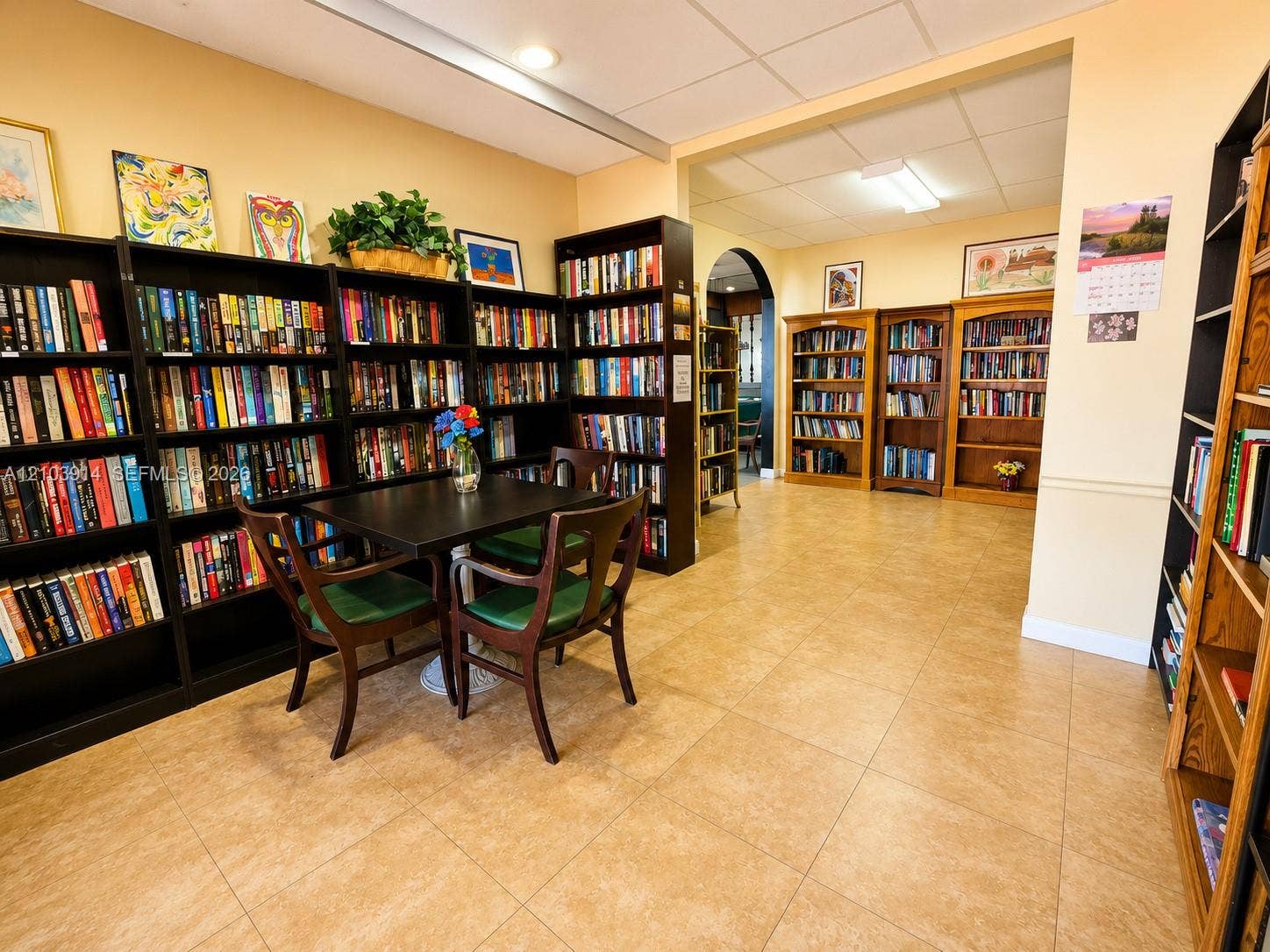 Built-in floor-to-ceiling shelving, recessed ceiling lighting, and tile flooring