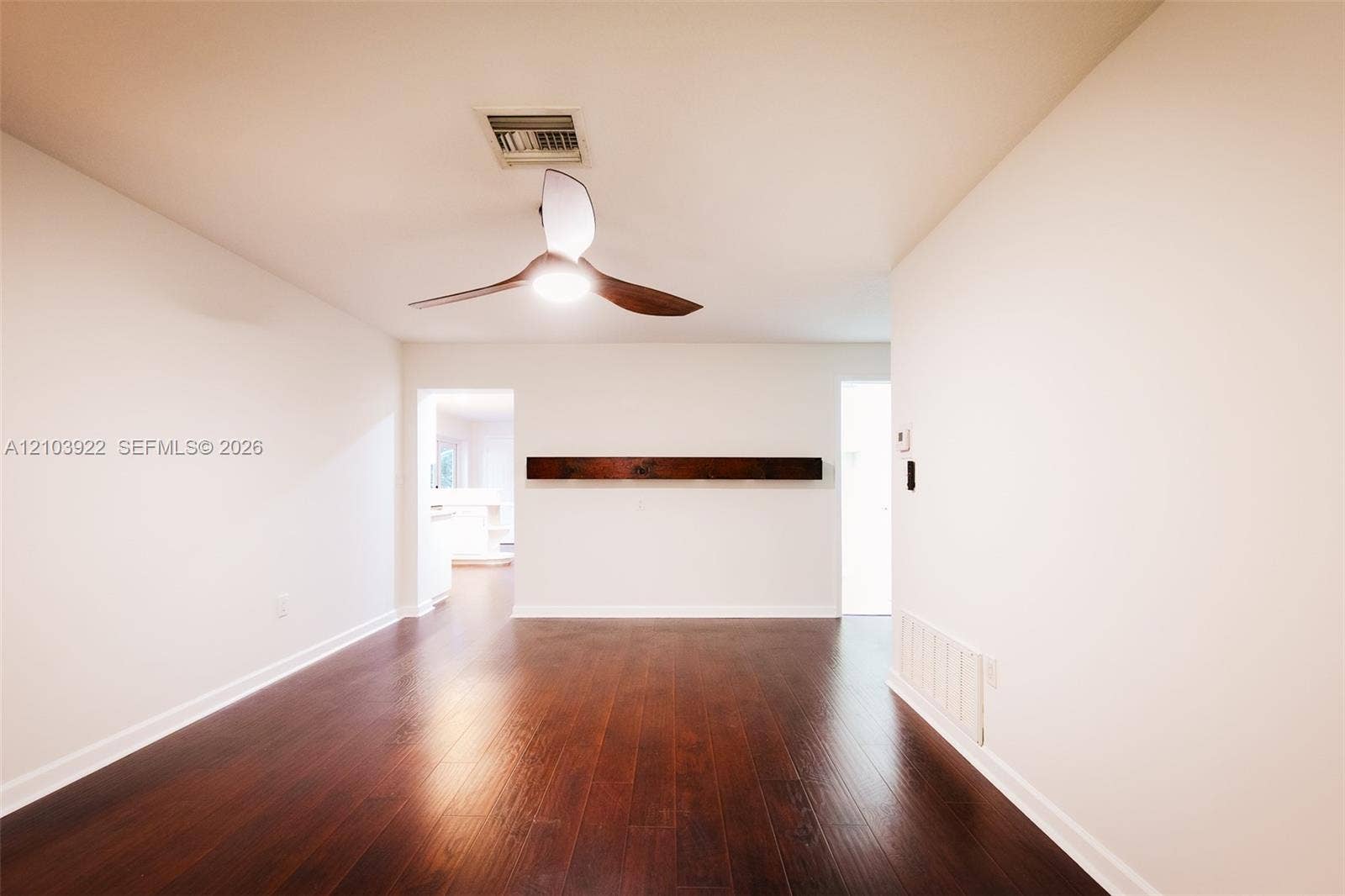 Recessed lighting, wood-finish flooring, and a ceiling fan with integrated lighting
