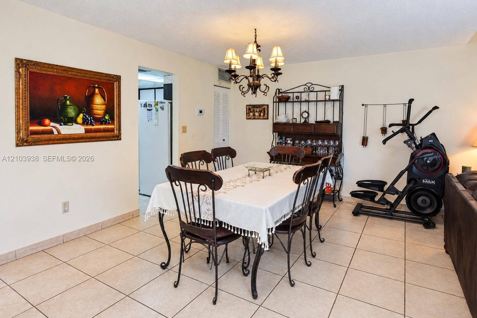 11335 SW 71st Lane, Miami, FL 33173 Ceramic tile flooring, crown-style six-arm chandelier, and louvered closet doors