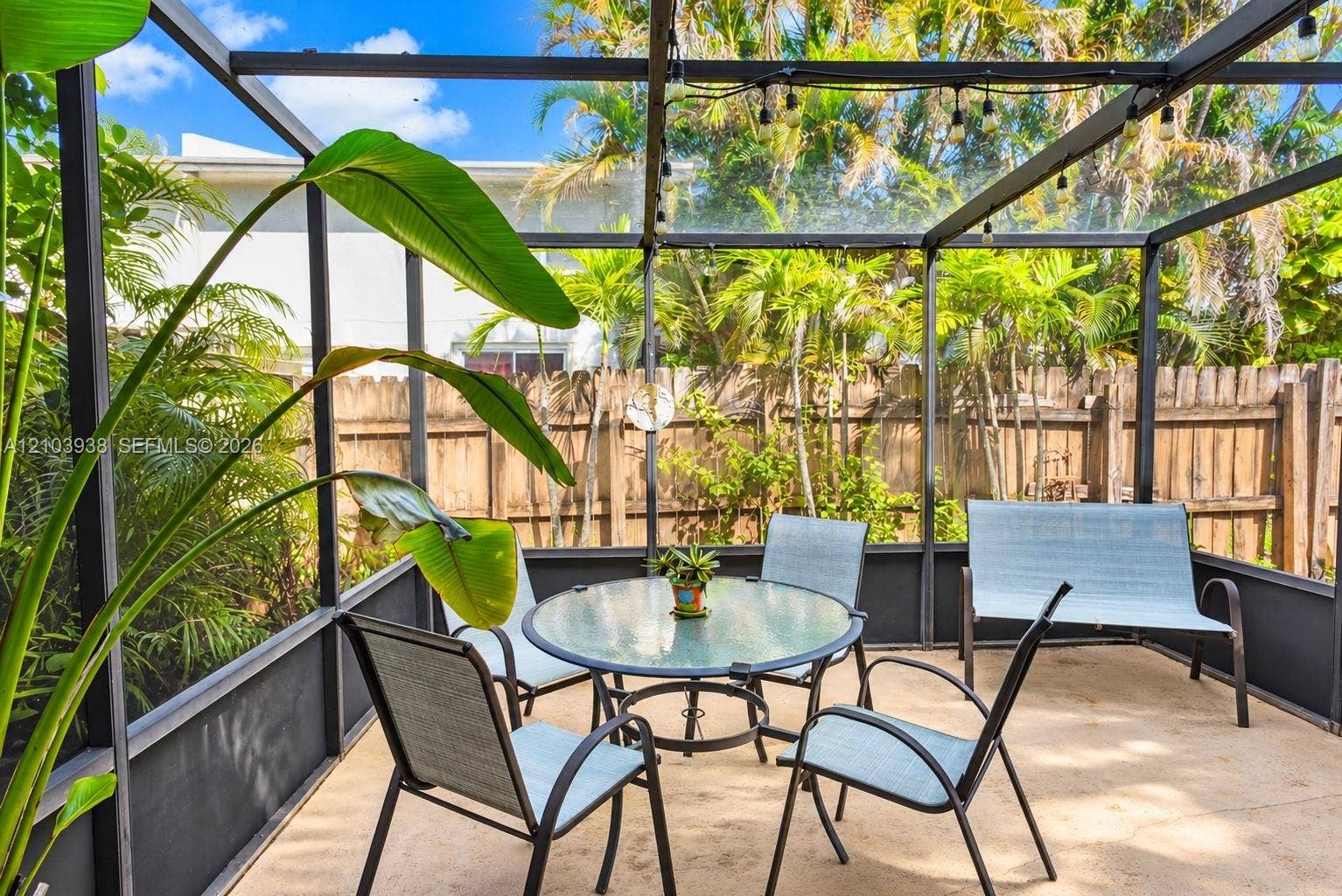 11335 SW 71st Lane, Miami, FL 33173 Screened-in patio featuring a concrete floor, metal framing, and a wood privacy fence