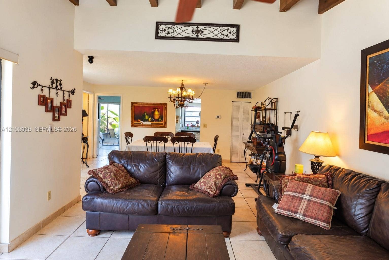 11335 SW 71st Lane, Miami, FL 33173 Exposed timber ceiling beams, ceramic tile flooring, and decorative metal wall-mounted accents