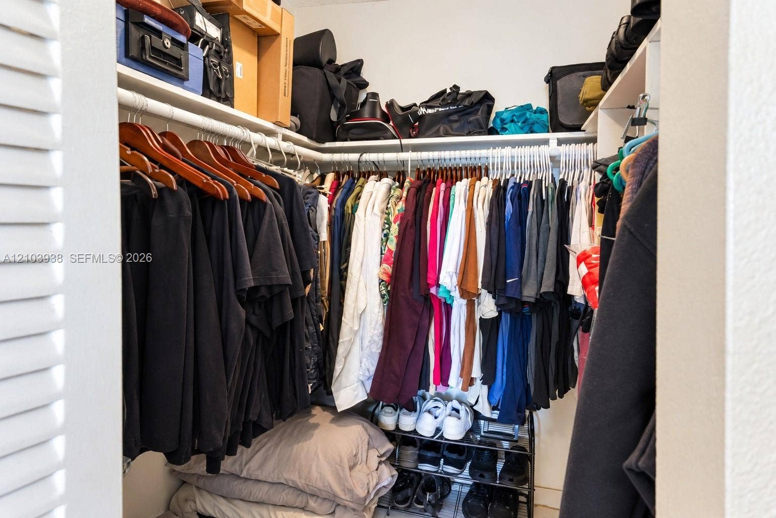 11335 SW 71st Lane, Miami, FL 33173 Walk-in closet featuring multi-level built-in shelving and dual-tier hanging rods