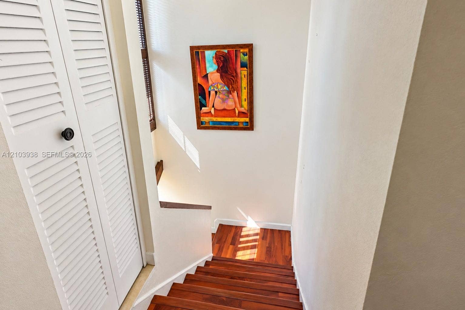 11335 SW 71st Lane, Miami, FL 33173 Staircase featuring wood-finish treads and white louvered bifold doors