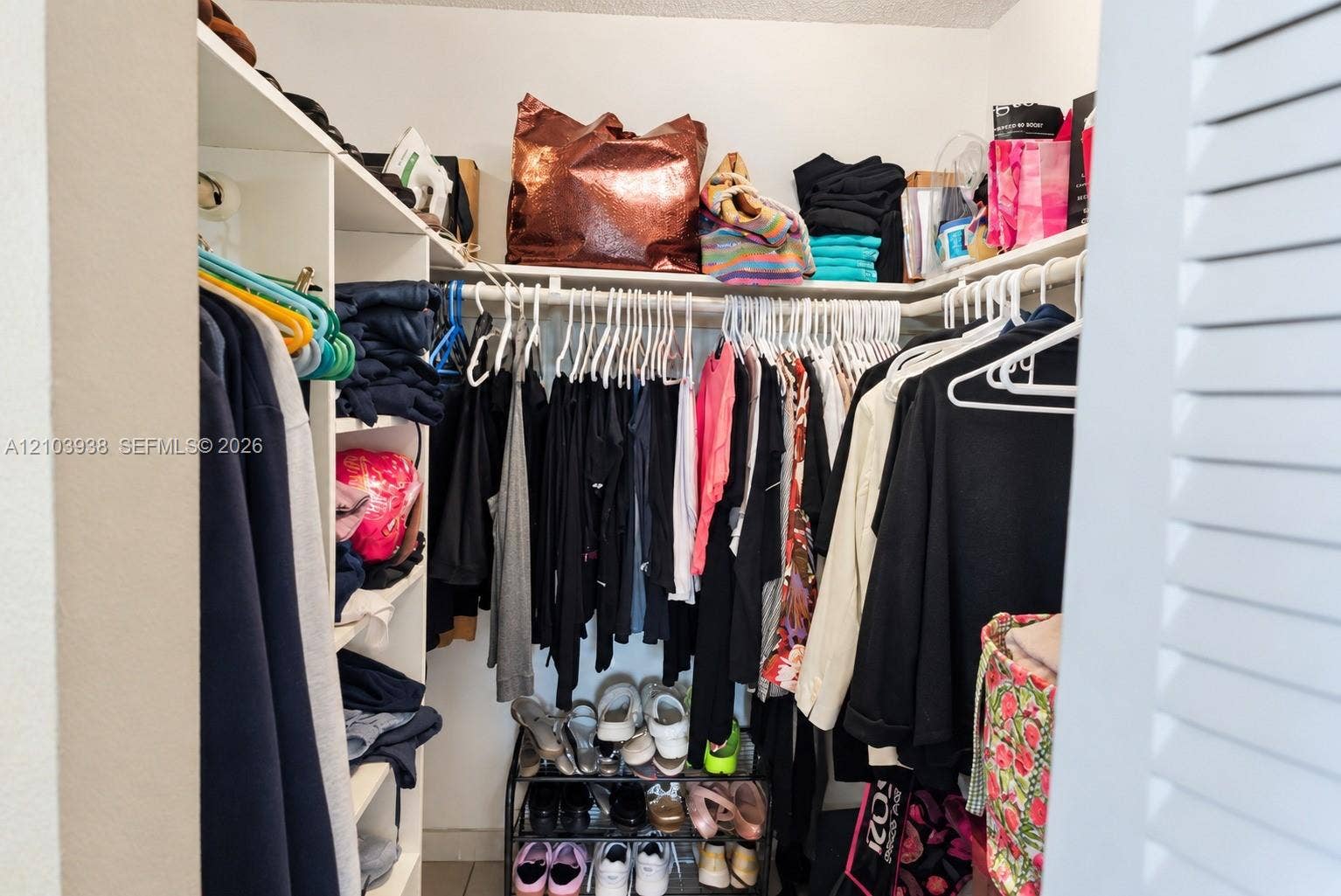 11335 SW 71st Lane, Miami, FL 33173 Walk-in closet featuring white built-in shelving and tiered hanging rods