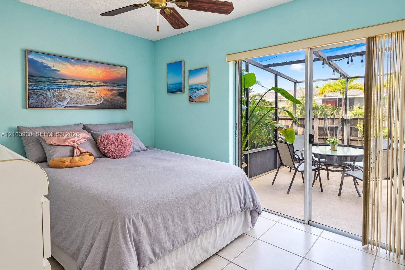 11335 SW 71st Lane, Miami, FL 33173 Ceramic tile flooring, ceiling fan, and sliding glass doors opening to a screened-in patio