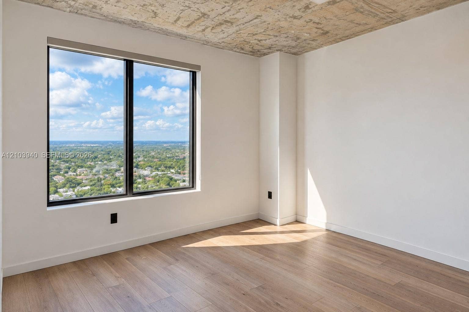 307 SW 5th Street, #2610, Fort Lauderdale, Fort Lauderdale, FL 33315 Exposed concrete ceiling, large window with expansive exterior scenery, and wood-finish flooring