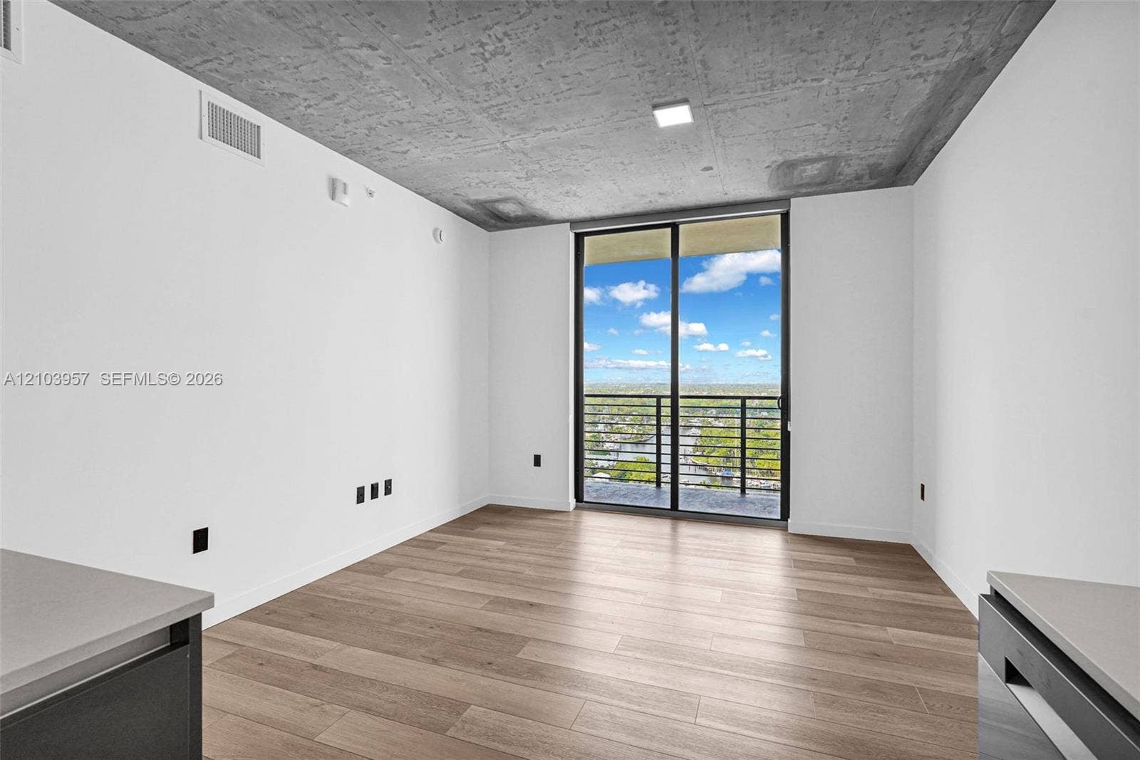 307 SW 5th Street, #0, Fort Lauderdale, Fort Lauderdale, FL 33315 Wood-finish flooring, white walls, and an exposed concrete ceiling