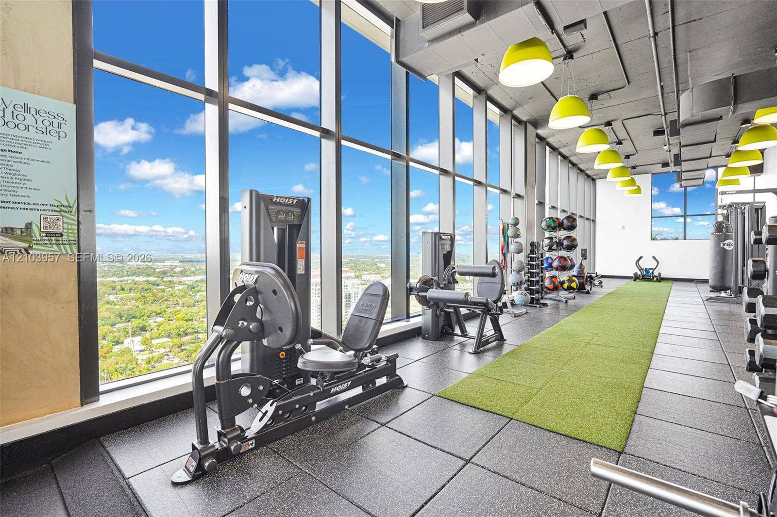 307 SW 5th Street, #0, Fort Lauderdale, Fort Lauderdale, FL 33315 Floor-to-ceiling windows, high ceilings with exposed ductwork, modern pendant lighting, resilient rubber flooring, and an artificial turf track