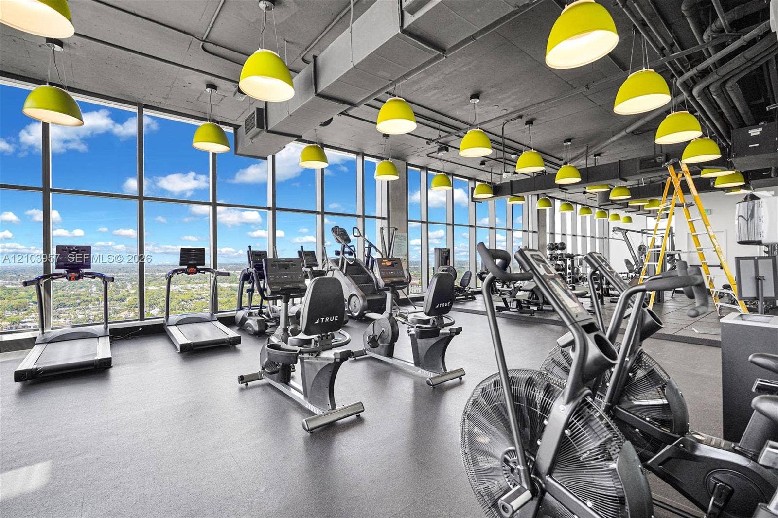 307 SW 5th Street, #0, Fort Lauderdale, Fort Lauderdale, FL 33315 Floor-to-ceiling windows, exposed structural ceiling, high-level urban scenery, suspended pendant lighting, and durable flooring