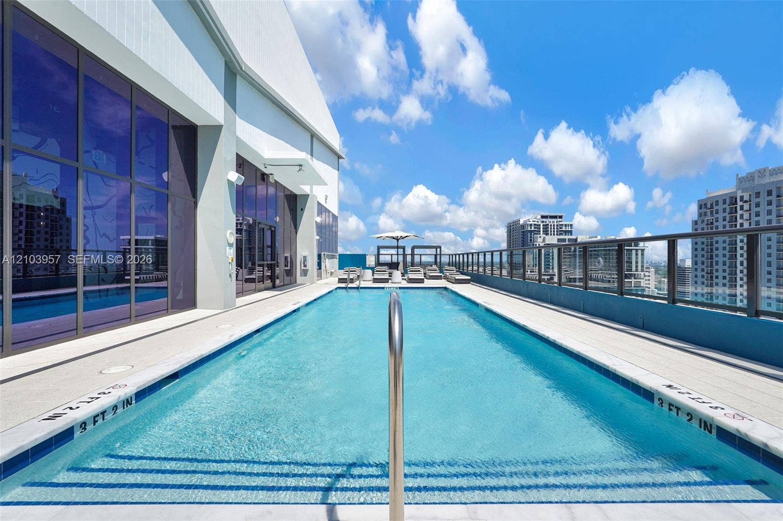 307 SW 5th Street, #0, Fort Lauderdale, Fort Lauderdale, FL 33315 Rooftop swimming pool with integrated steps, glass panel railing, and surrounding paver decking