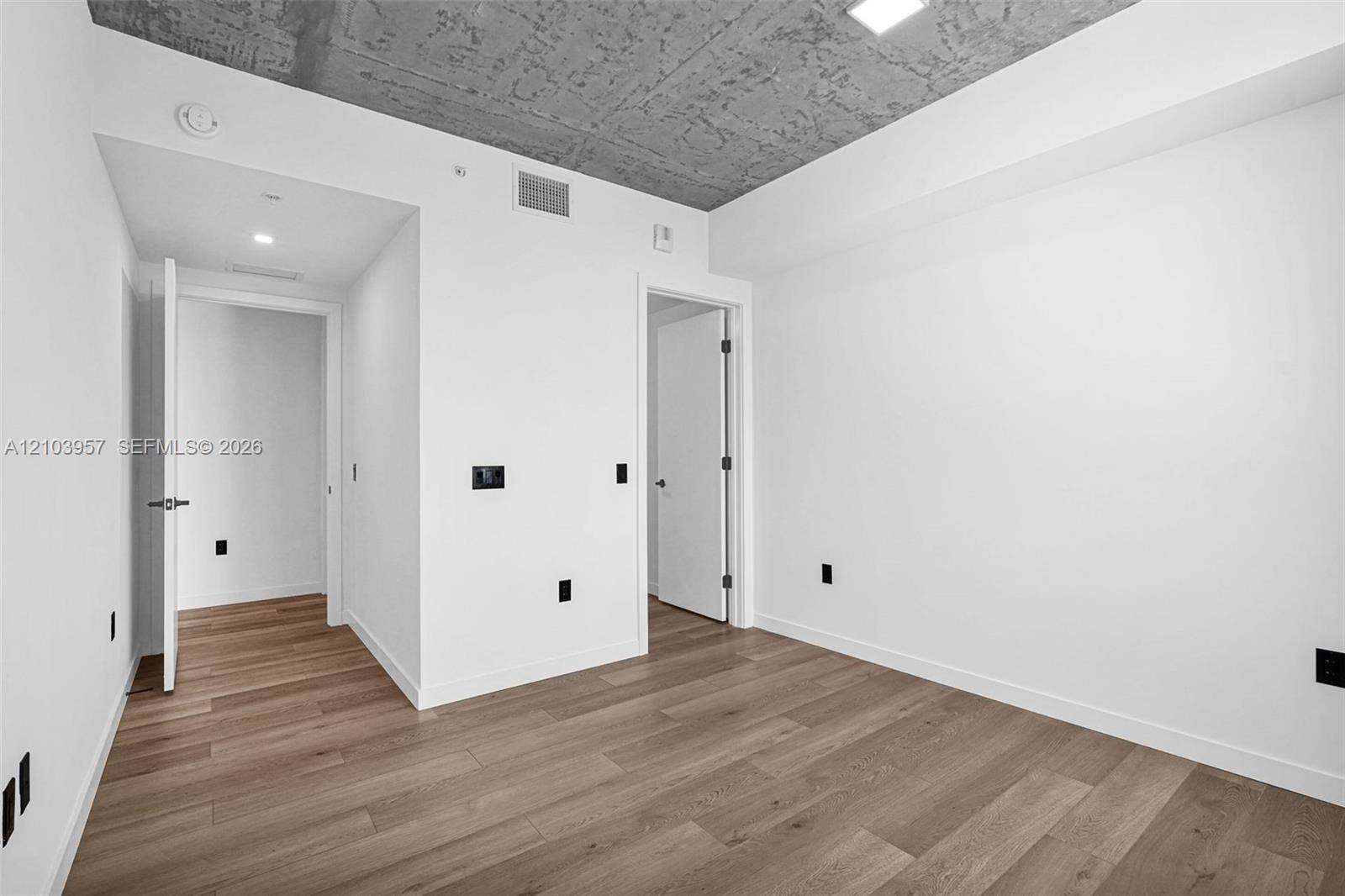 307 SW 5th Street, #0, Fort Lauderdale, Fort Lauderdale, FL 33315 Hardwood-style flooring throughout, smooth white walls, recessed lighting, and a textured concrete ceiling