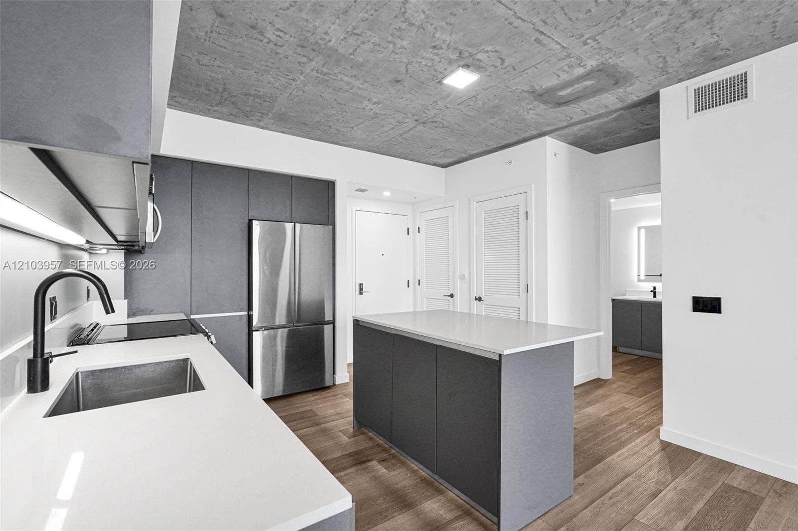 307 SW 5th Street, #0, Fort Lauderdale, Fort Lauderdale, FL 33315 Kitchen featuring a center island, white countertops, dark gray cabinetry, stainless steel appliances, and wood-finish flooring