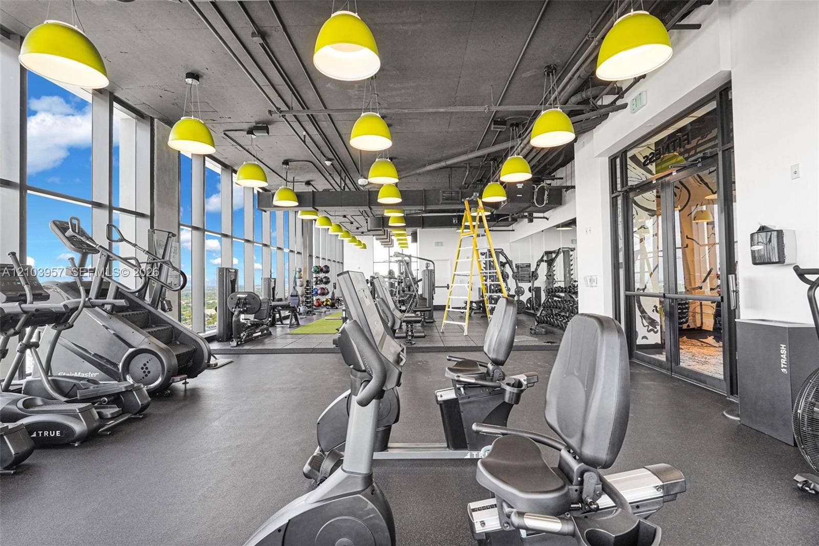 307 SW 5th Street, #0, Fort Lauderdale, Fort Lauderdale, FL 33315 Floor-to-ceiling windows, exposed ceiling infrastructure, multiple pendant light fixtures, and dedicated exercise equipment