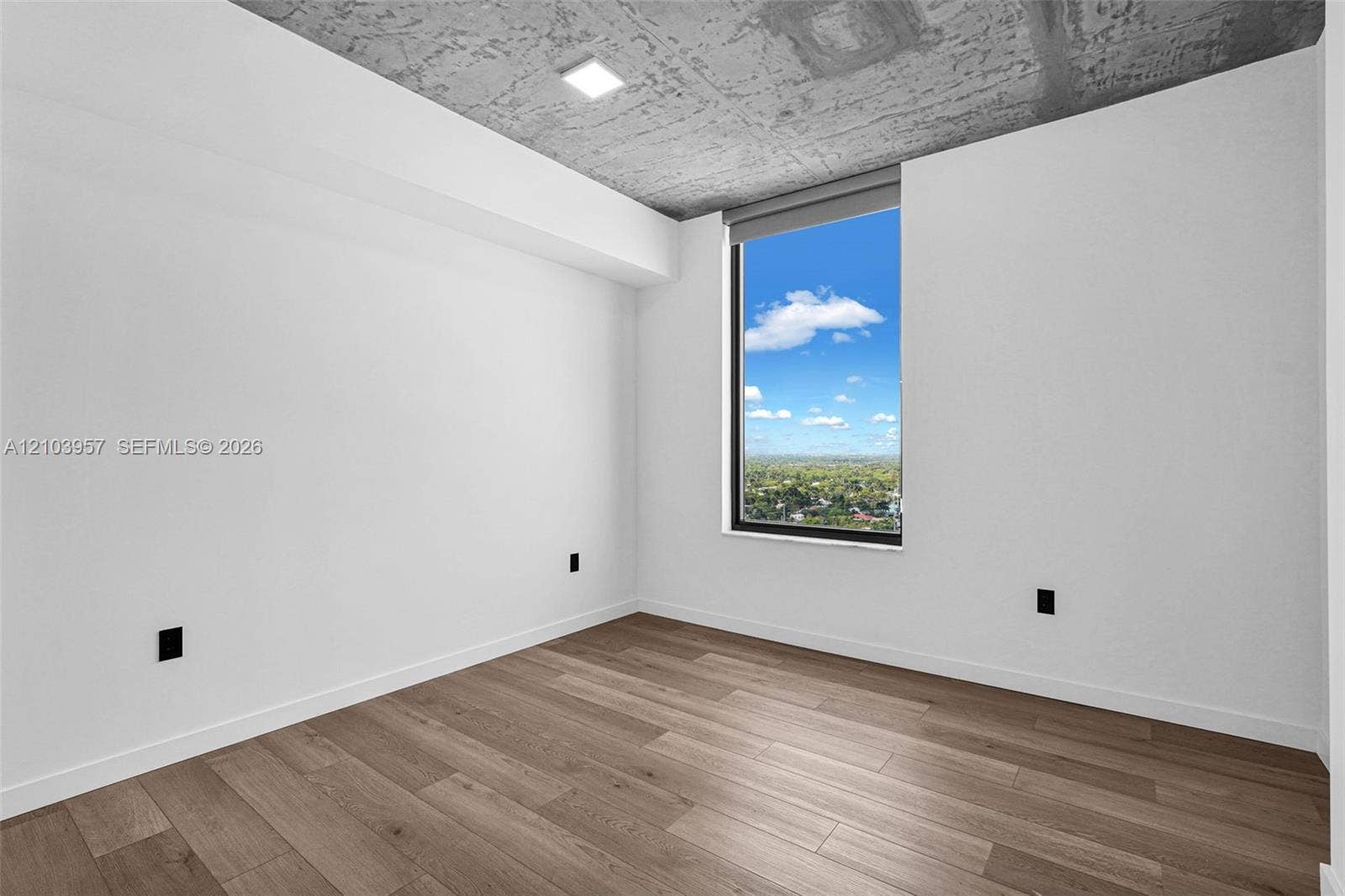 307 SW 5th Street, #0, Fort Lauderdale, Fort Lauderdale, FL 33315 Expansive window, concrete ceiling, wood-finish flooring, recessed lighting, and white walls