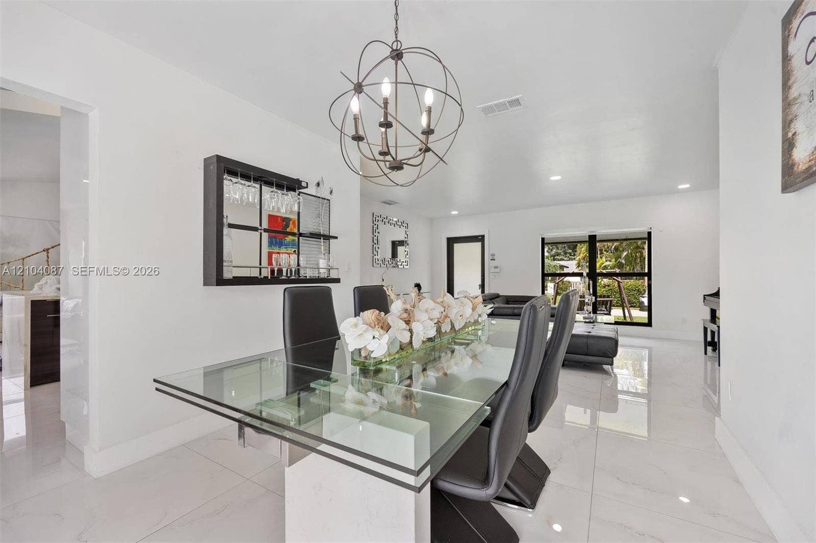 White tile flooring throughout, with a glass-top dining table