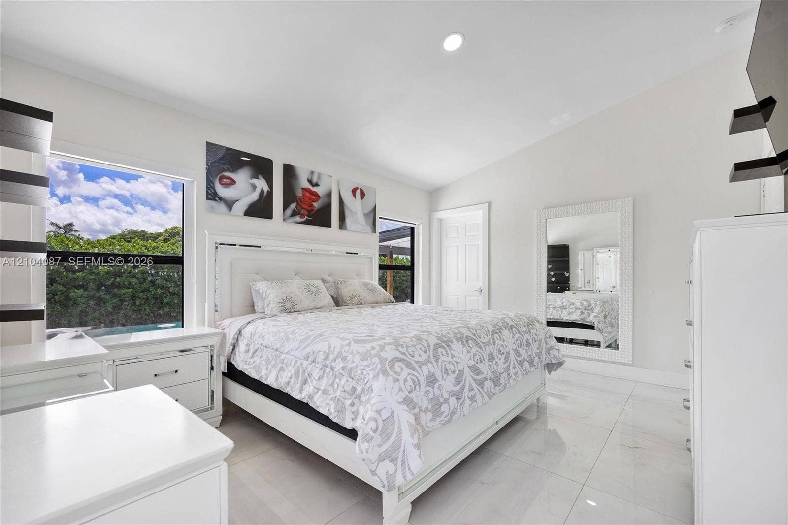 8840 SW 181st Terrace, Palmetto Bay, FL 33157 White tile flooring, vaulted ceiling, large windows, recessed lighting, and a white paneled door