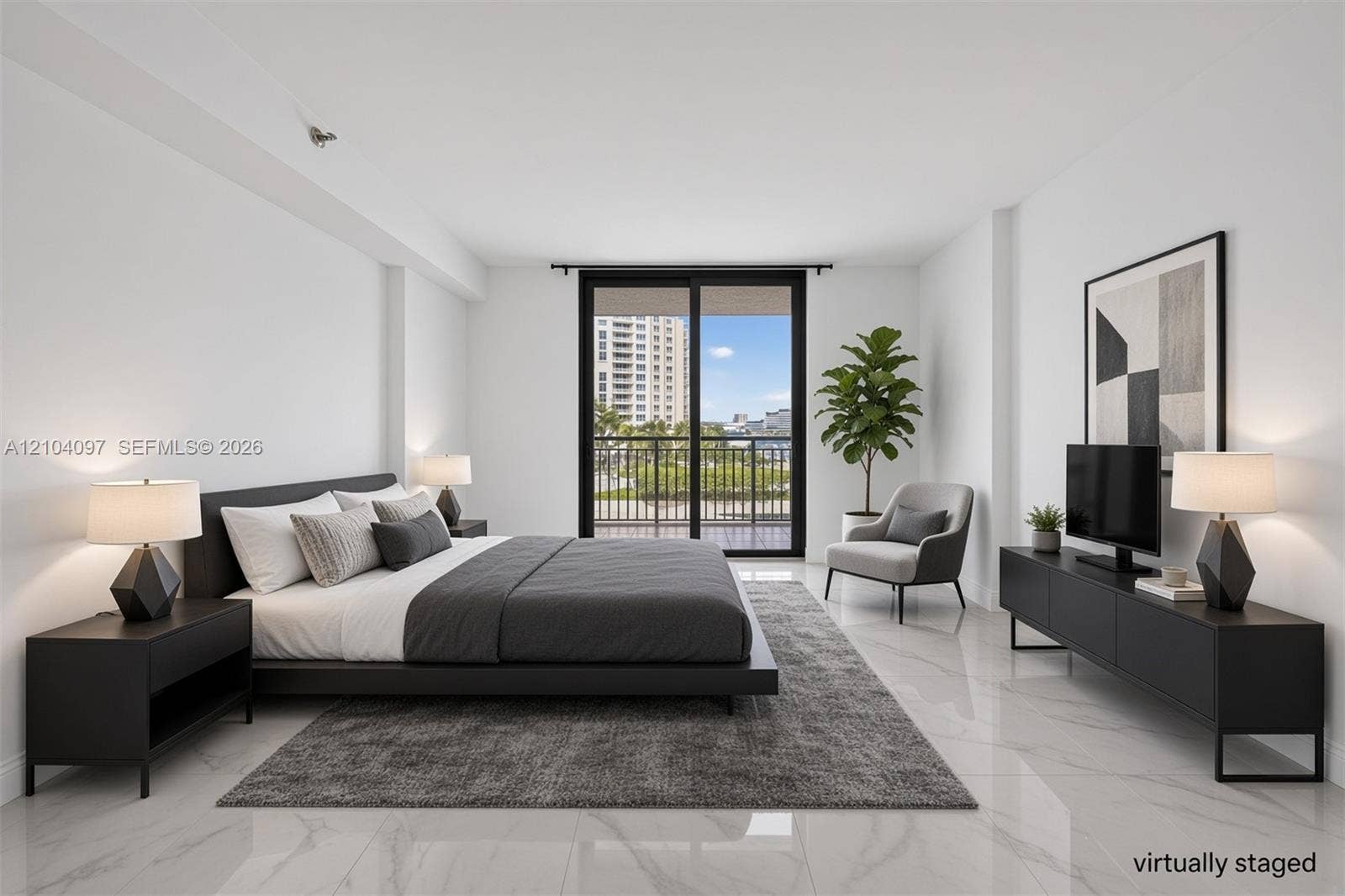 540 Brickell Key Drive, #916, Miami, Miami, FL 33131 Spacious room featuring polished stone-finish flooring and large sliding glass doors opening to a balcony with metal railing