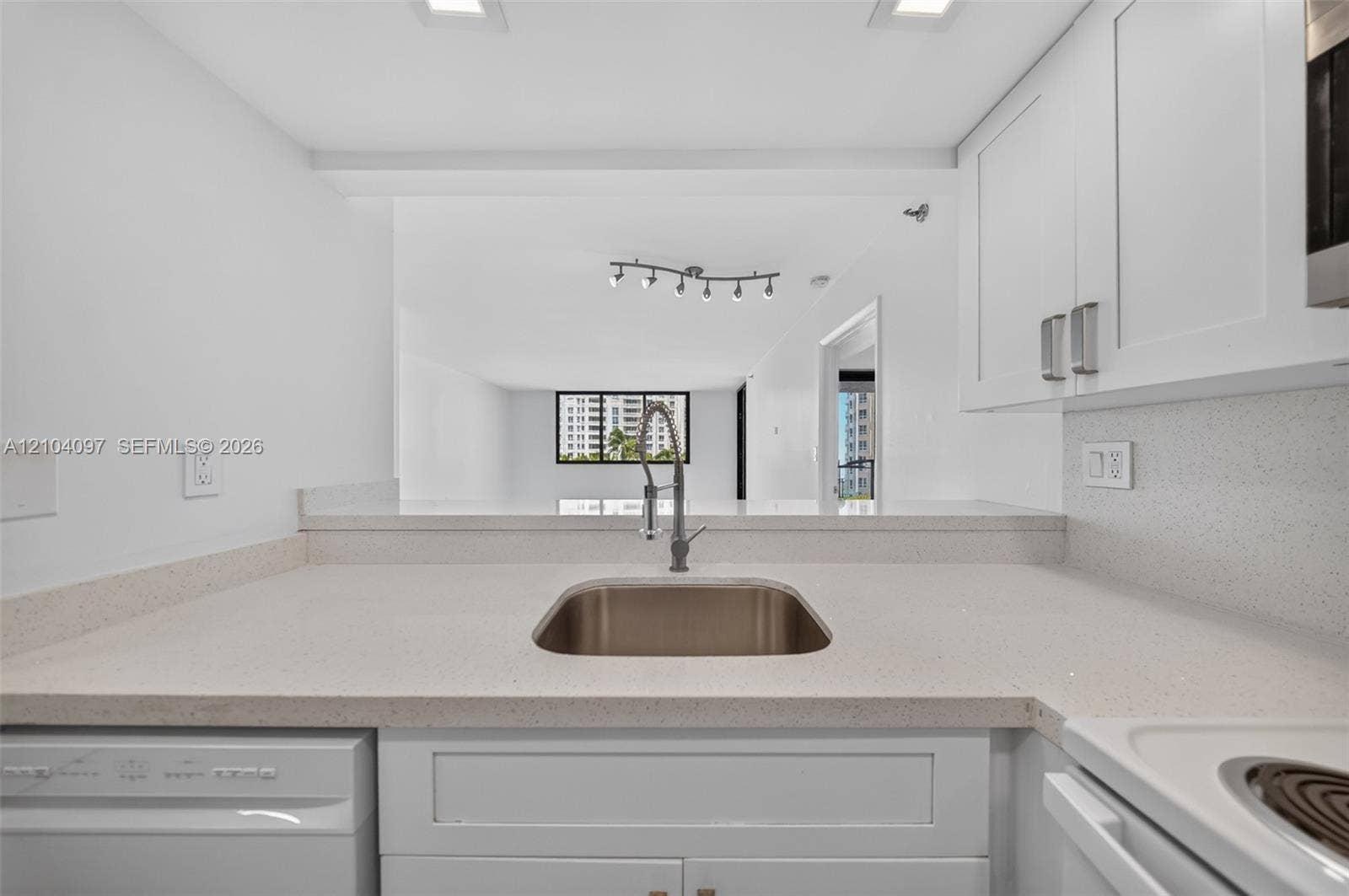 540 Brickell Key Drive, #916, Miami, Miami, FL 33131 Kitchen featuring white cabinetry, solid surface countertops, stainless steel undermount sink with gooseneck faucet, and recessed ceiling lighting