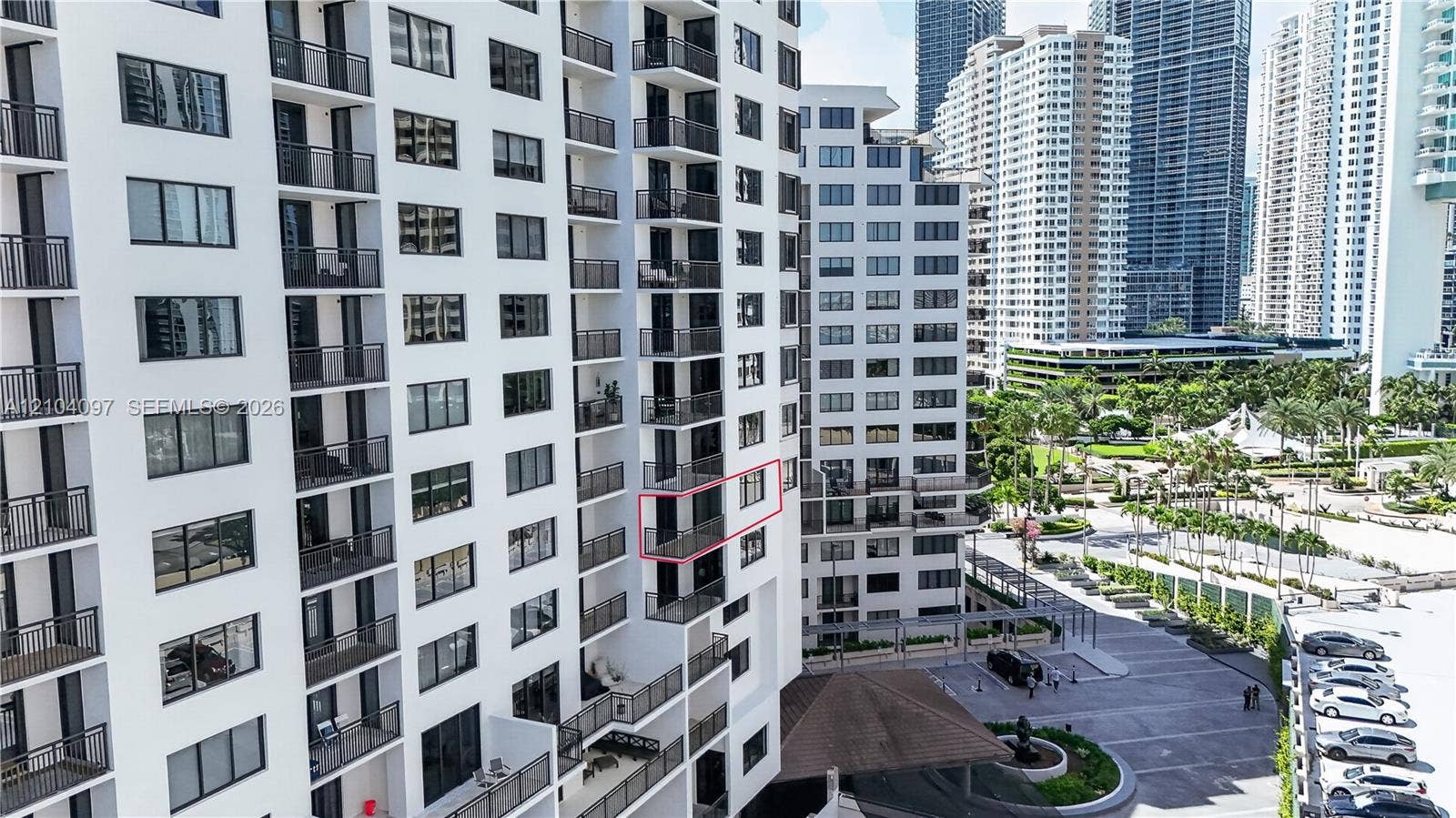 540 Brickell Key Drive, #916, Miami, Miami, FL 33131 High-rise residential building featuring stacked private balconies, uniform multi-pane windows, and a paved exterior motor court