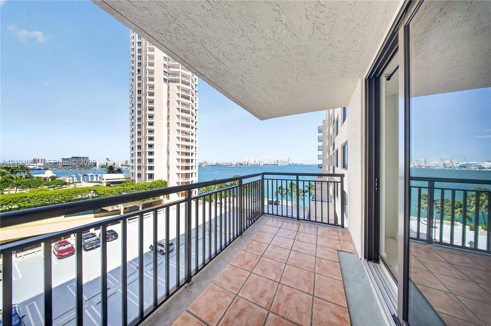 540 Brickell Key Drive, #916, Miami, Miami, FL 33131 Covered balcony featuring tile flooring and metal railings, accessible via full-height glass sliding doors