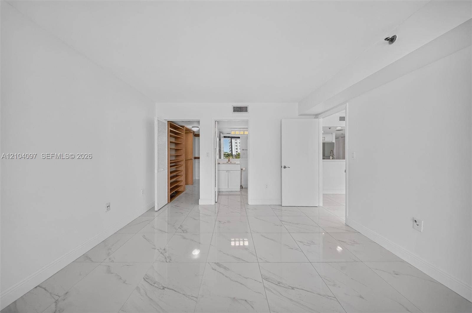 540 Brickell Key Drive, #916, Miami, Miami, FL 33131 Large-format polished tile flooring, neutral wall finishes, built-in shelving, and white interior doors