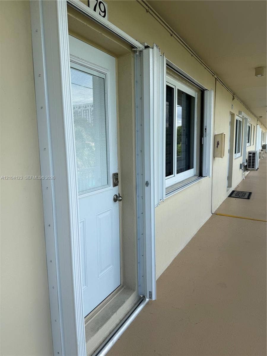 Entry door with partial glass insert and brushed metal hardware
