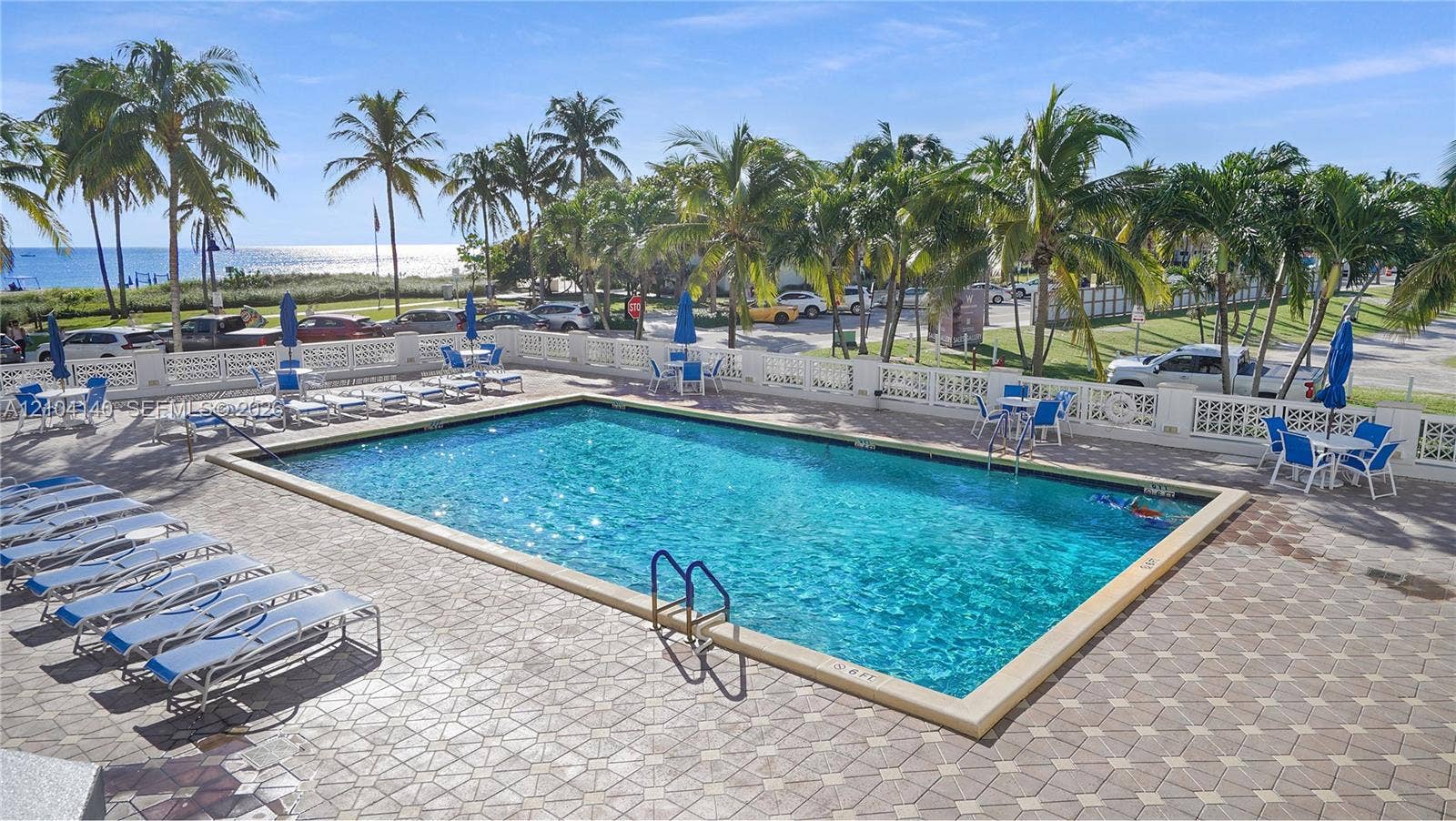 111 N Pompano Beach Boulevard, #304, Pompano Beach, FL 33062 Rectangular swimming pool featuring a concrete paver deck and decorative balustrade perimeter
