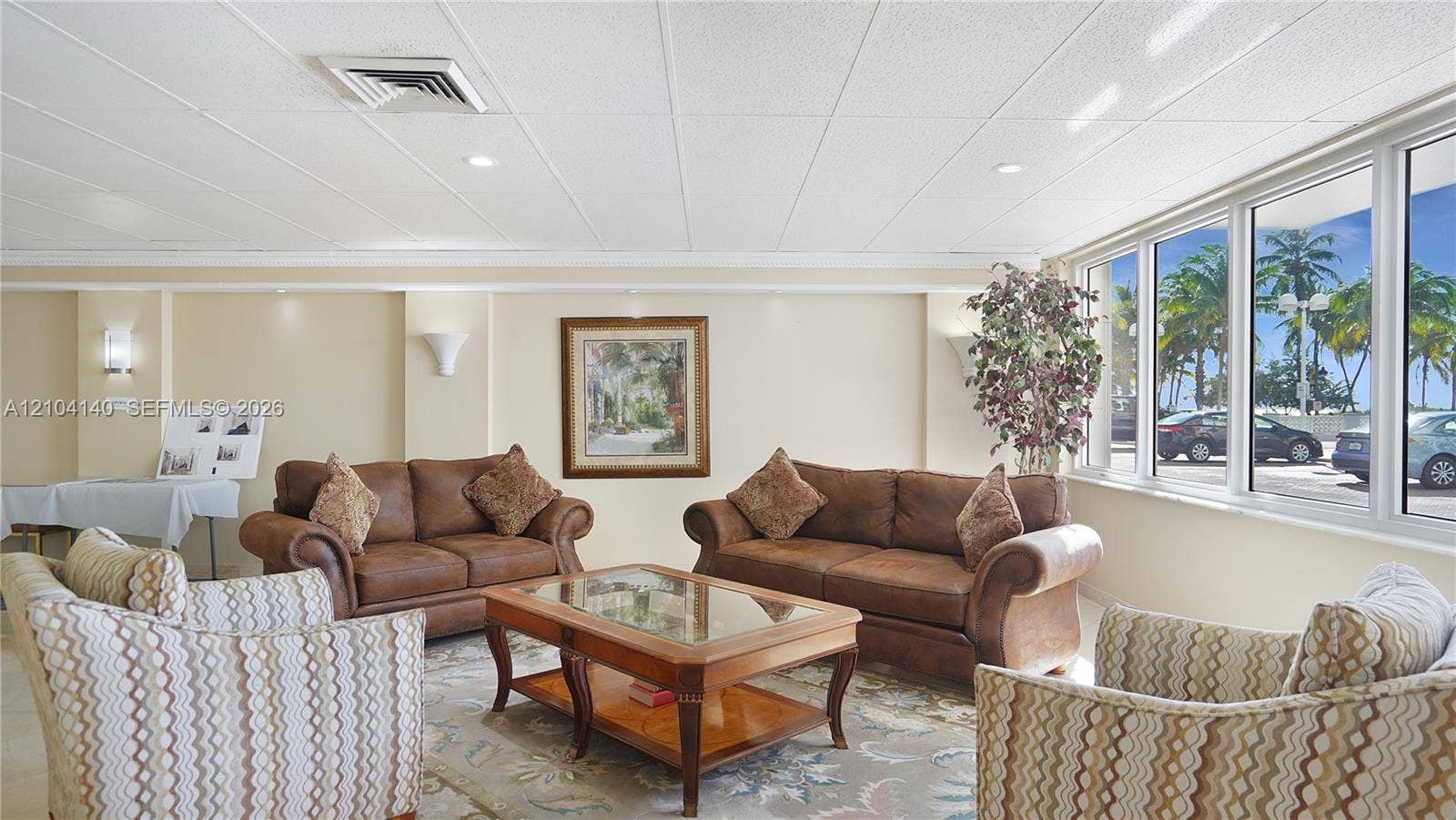 111 N Pompano Beach Boulevard, #304, Pompano Beach, FL 33062 Expansive windows providing natural light, neutral wall finishes, recessed lighting, and wall-mounted sconces