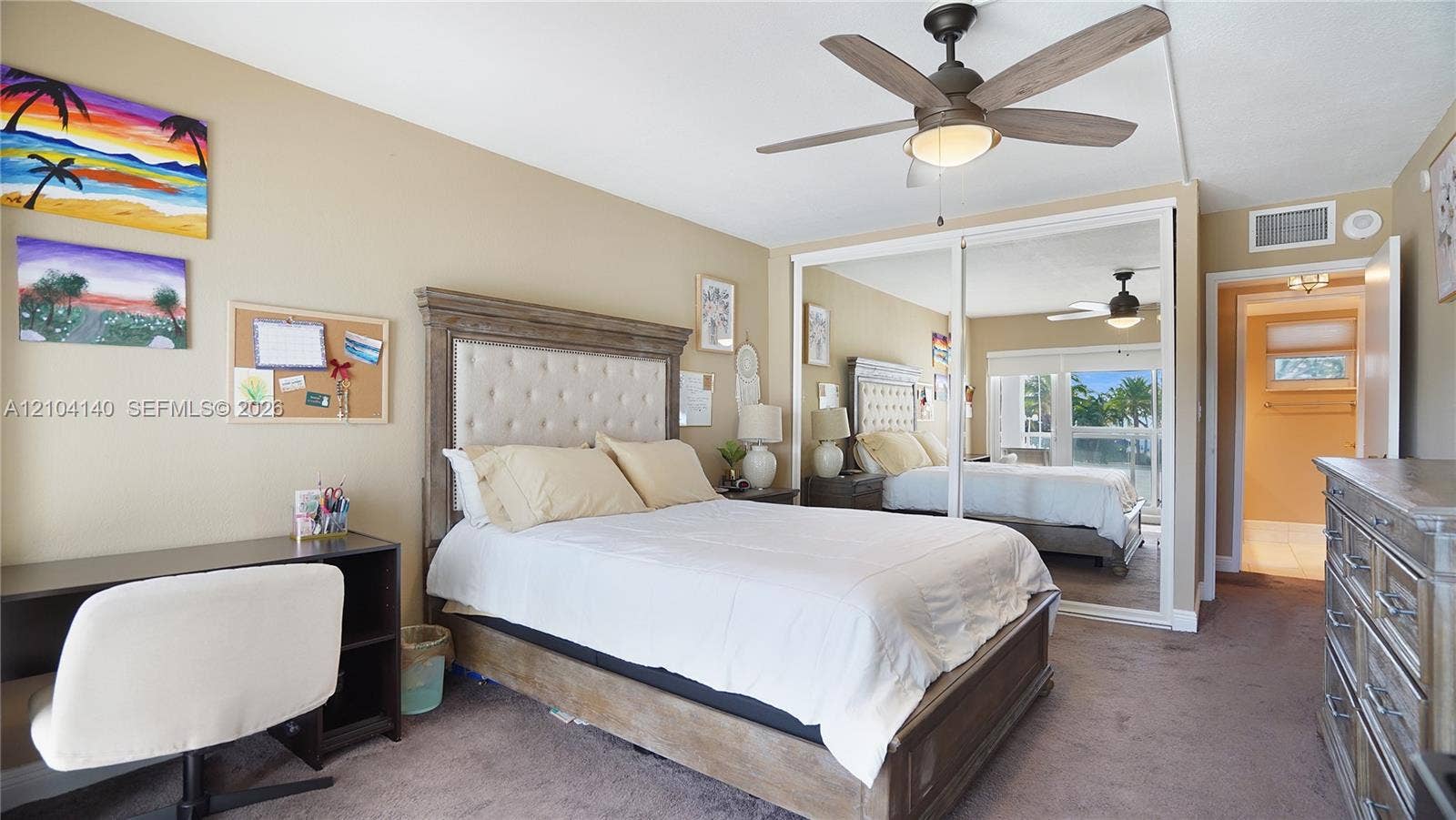 111 N Pompano Beach Boulevard, #304, Pompano Beach, FL 33062 Room featuring a ceiling fan with integrated lighting and sliding mirrored closet doors