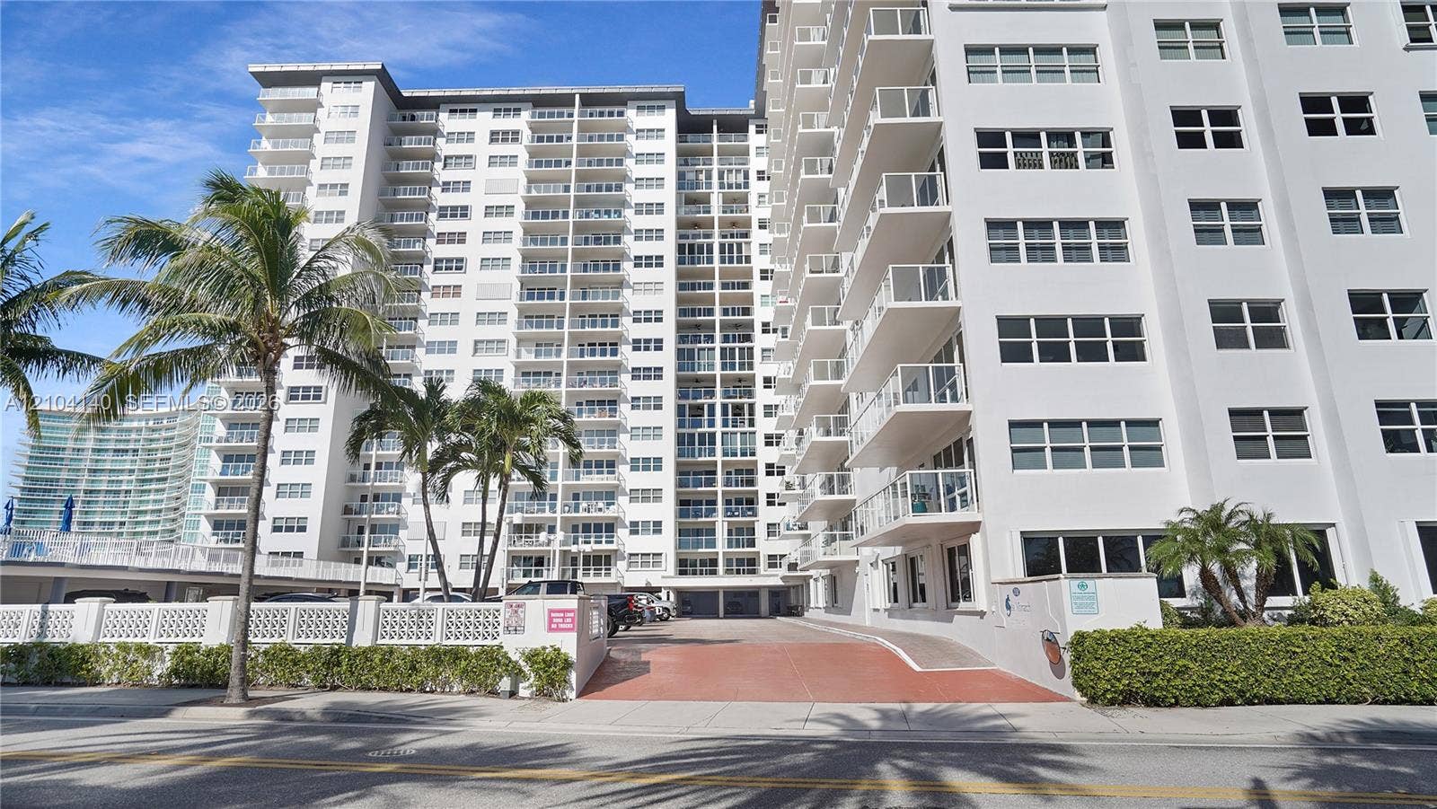 111 N Pompano Beach Boulevard, #304, Pompano Beach, FL 33062 Multi-story high-rise exterior featuring a reinforced concrete facade, private balconies with glass railings, and ground-level paved parking