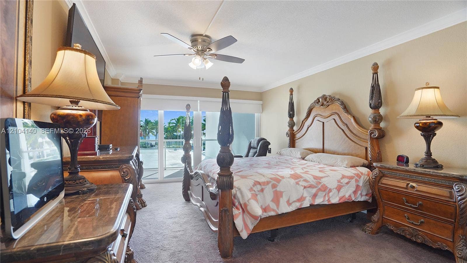 111 N Pompano Beach Boulevard, #304, Pompano Beach, FL 33062 Carpeted interior featuring a ceiling fan with integrated lighting and sliding glass doors with access to an exterior balcony