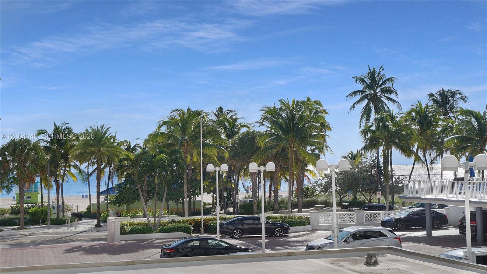 111 N Pompano Beach Boulevard, #304, Pompano Beach, FL 33062 Coastal landscape featuring mature palm trees, white sand, and direct proximity to the oceanfront