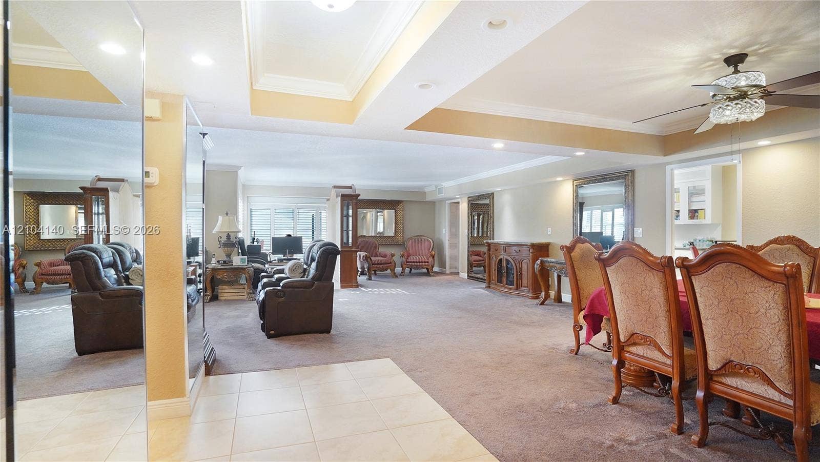 111 N Pompano Beach Boulevard, #304, Pompano Beach, FL 33062 Open-concept interior featuring recessed tray ceilings, large-format tile flooring, wall-to-wall carpeting, and recessed lighting