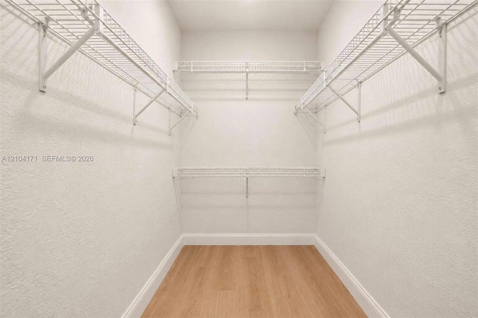 745 NW 32nd Avenue, Miami, FL 33125 Walk-in storage space featuring wood-finish flooring and multi-level white wire shelving