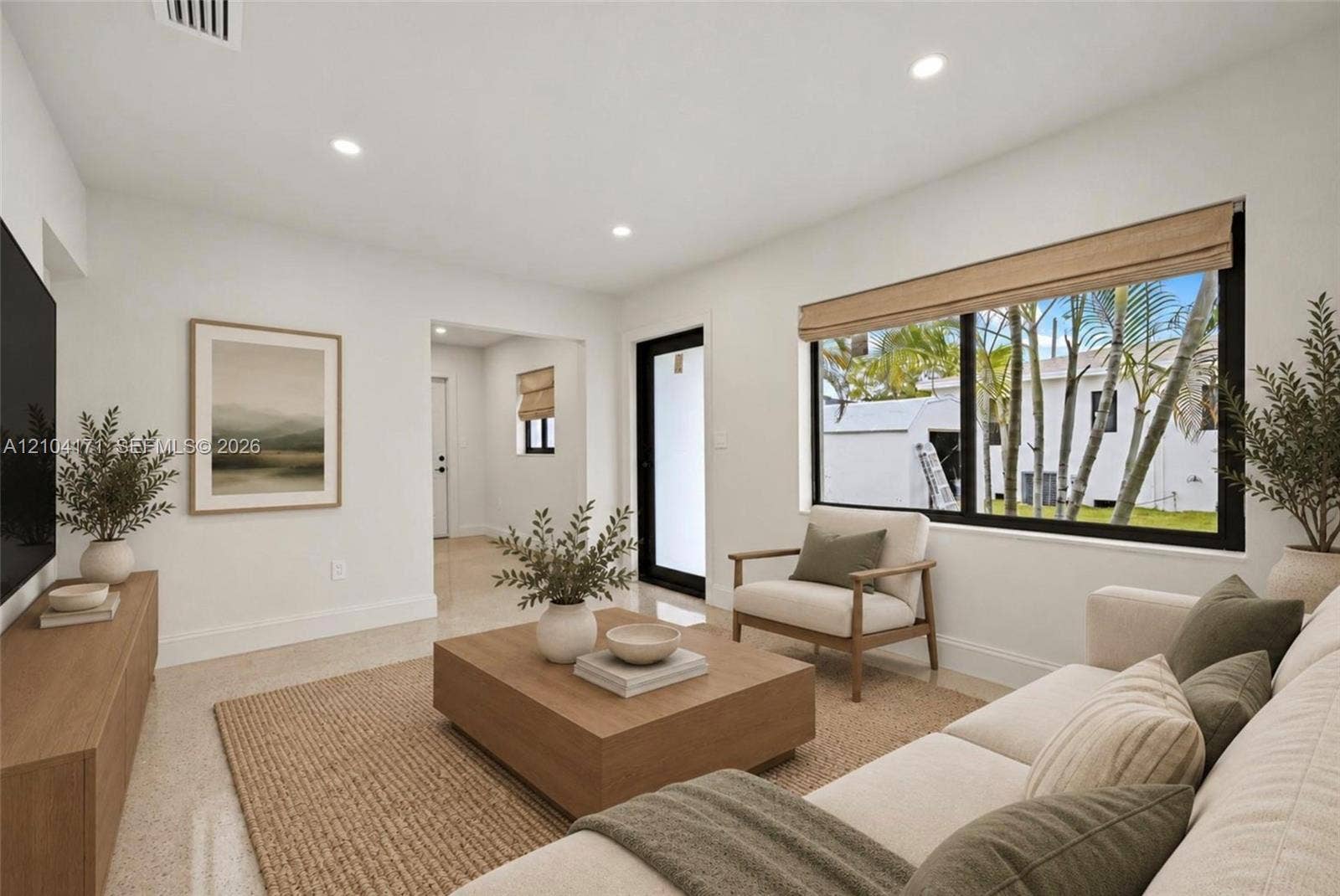 745 NW 32nd Avenue, Miami, FL 33125 Bright living space featuring neutral wall paint, recessed lighting, large picture windows with black trim, and polished stone-finish flooring