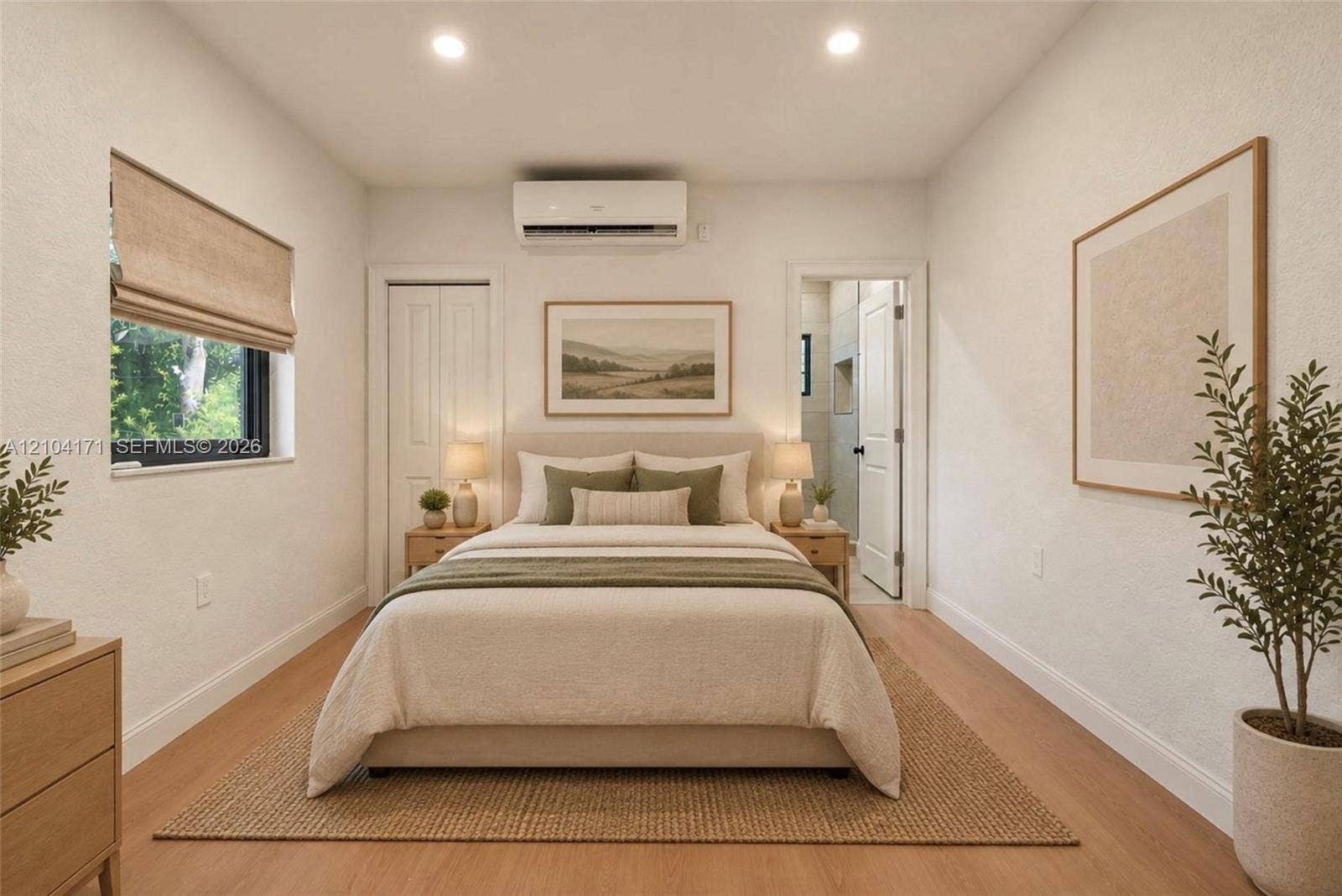 745 NW 32nd Avenue, Miami, FL 33125 Room featuring wood-finish flooring, a wall-mounted ductless air conditioning unit, recessed ceiling lighting, and a window with a fabric shade