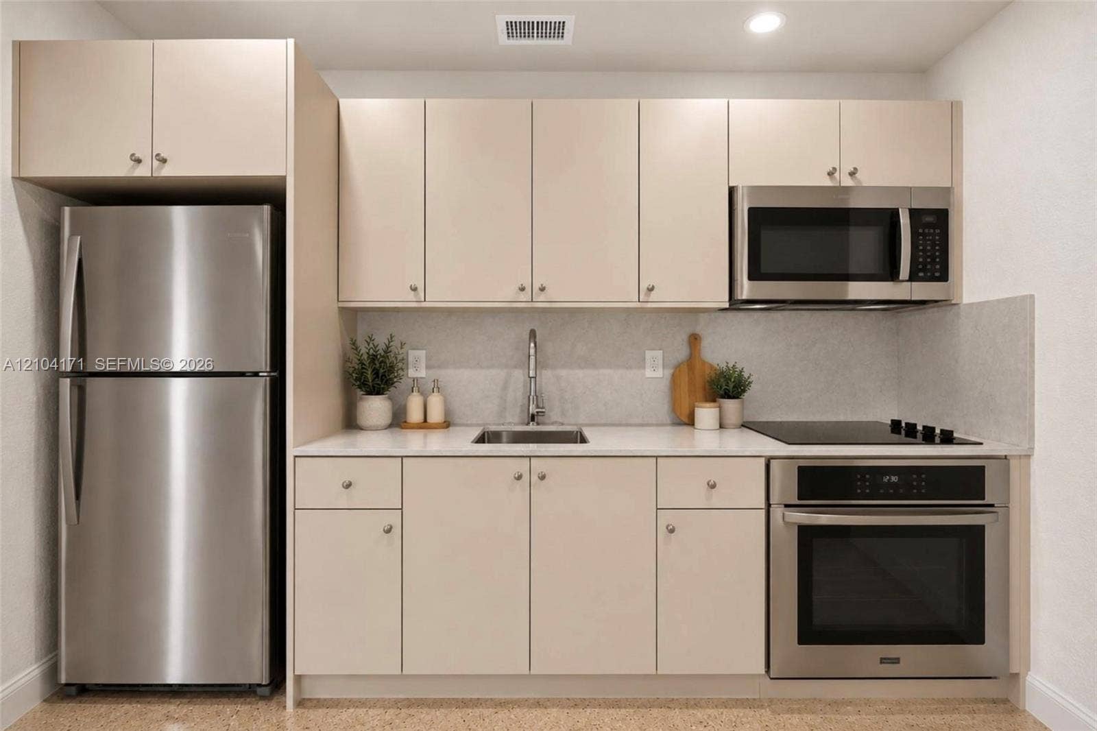 745 NW 32nd Avenue, Miami, FL 33125 Kitchen featuring matte finish cabinetry, solid surface countertops, stainless steel refrigerator, built-in oven, and over-the-range microwave