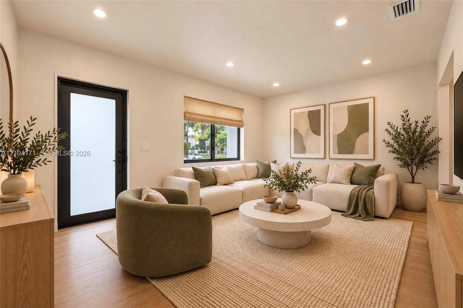 745 NW 32nd Avenue, Miami, FL 33125 Neutral walls, wood-finish flooring, recessed lighting, and a black-framed exterior door with frosted glass