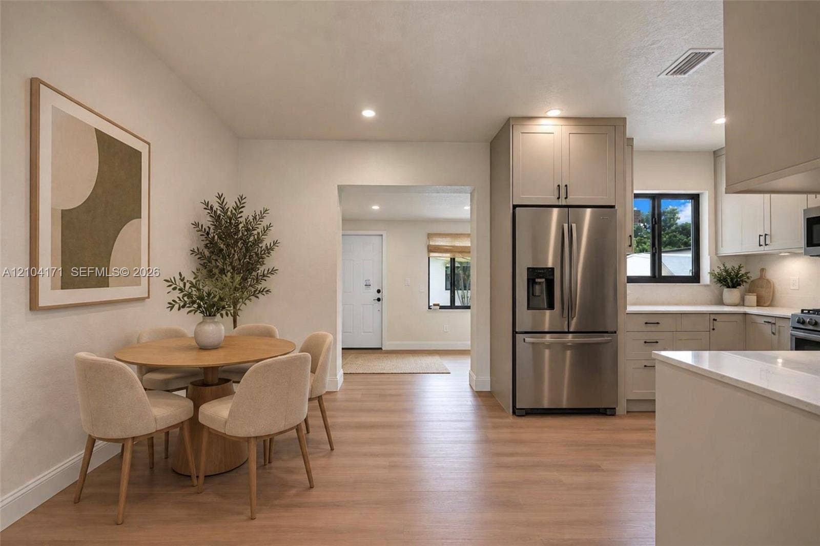 745 NW 32nd Avenue, Miami, FL 33125 Kitchen featuring light-toned cabinetry, stainless steel refrigerator, stone countertops, and wood-finish flooring