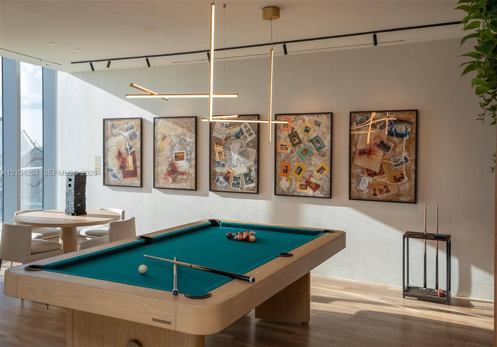 1400 Biscayne Boulevard, #1606, Miami, FL 33132 Modern light-filled room featuring wood-finish flooring, linear LED pendant lighting, and ceiling-mounted track lighting
