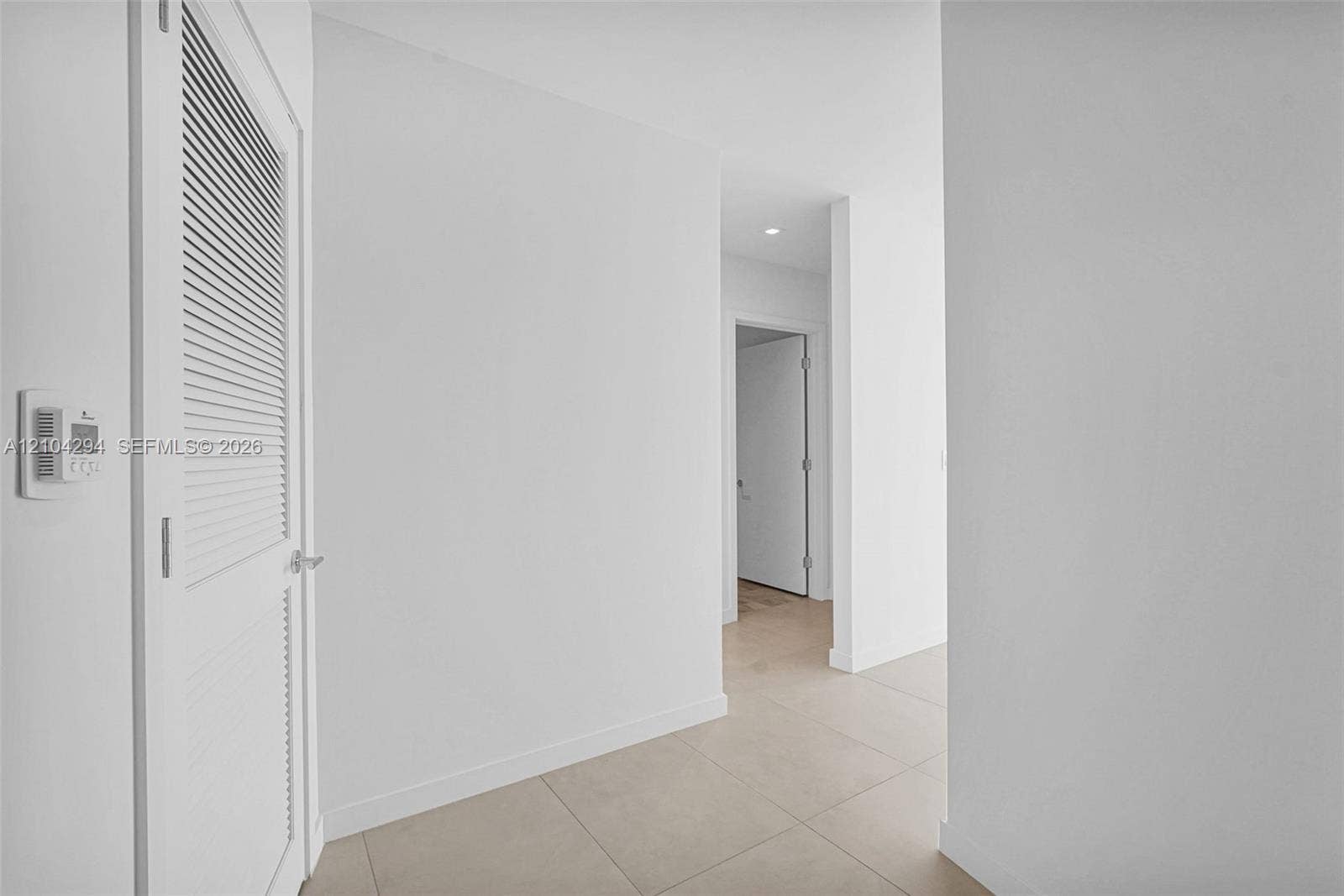 1400 Biscayne Boulevard, #1606, Miami, FL 33132 Louvered door, neutral tile flooring, recessed lighting, and crisp white walls