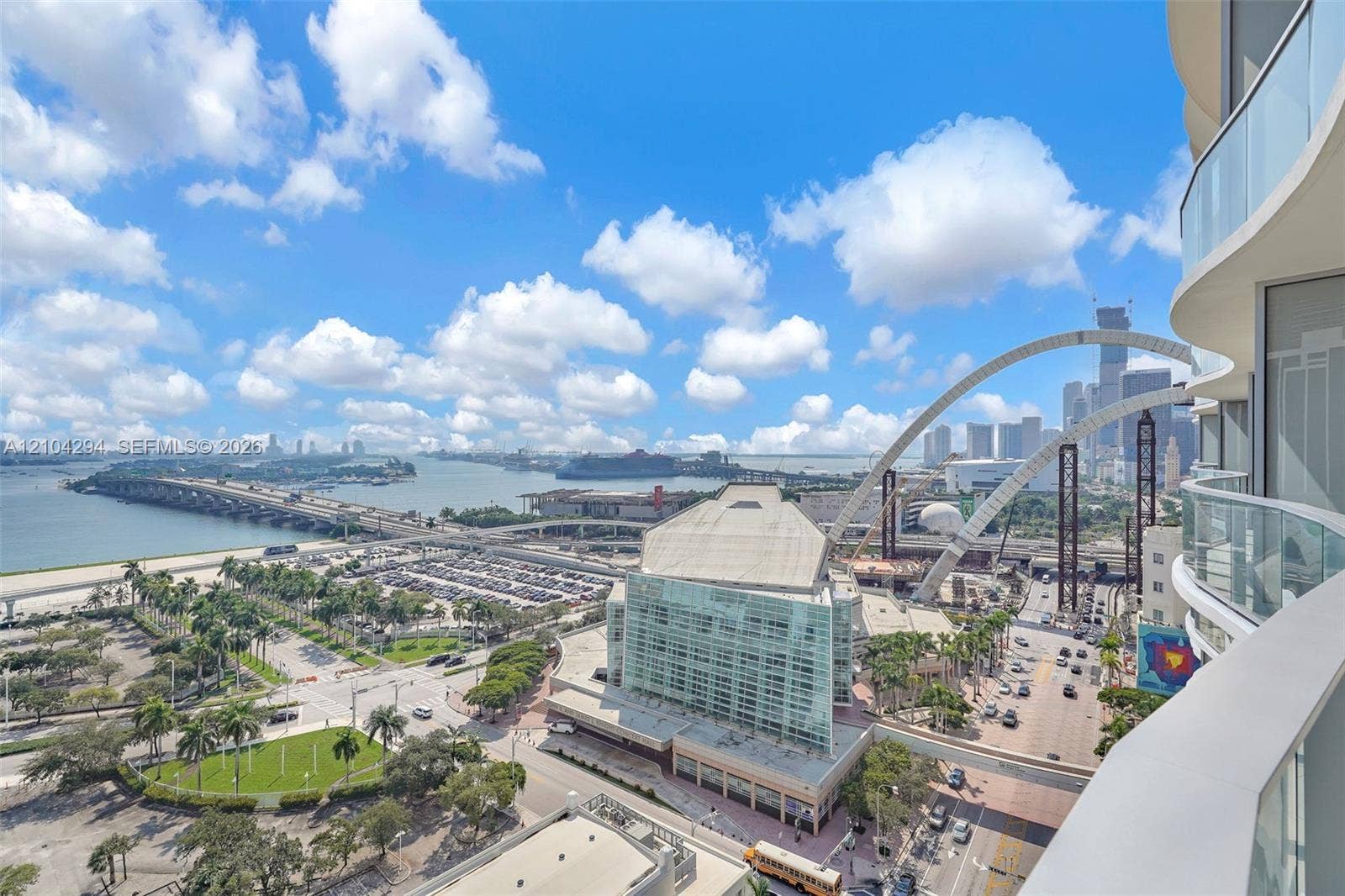 1400 Biscayne Boulevard, #1606, Miami, FL 33132 Curved balcony with glass railing, providing an expansive city and water backdrop
