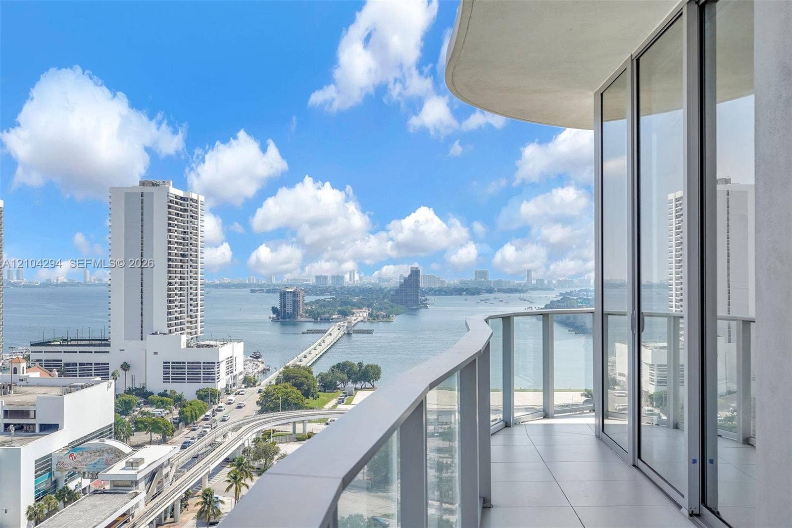 1400 Biscayne Boulevard, #1606, Miami, FL 33132 Balcony featuring a glass railing, sliding glass doors, and tile flooring