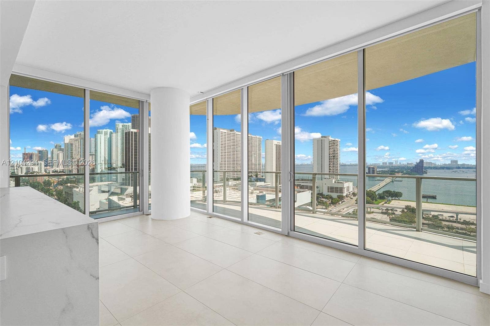 1400 Biscayne Boulevard, #1606, Miami, FL 33132 Floor-to-ceiling windows, white tile flooring, built-in counter with marbled finish, and roller shades
