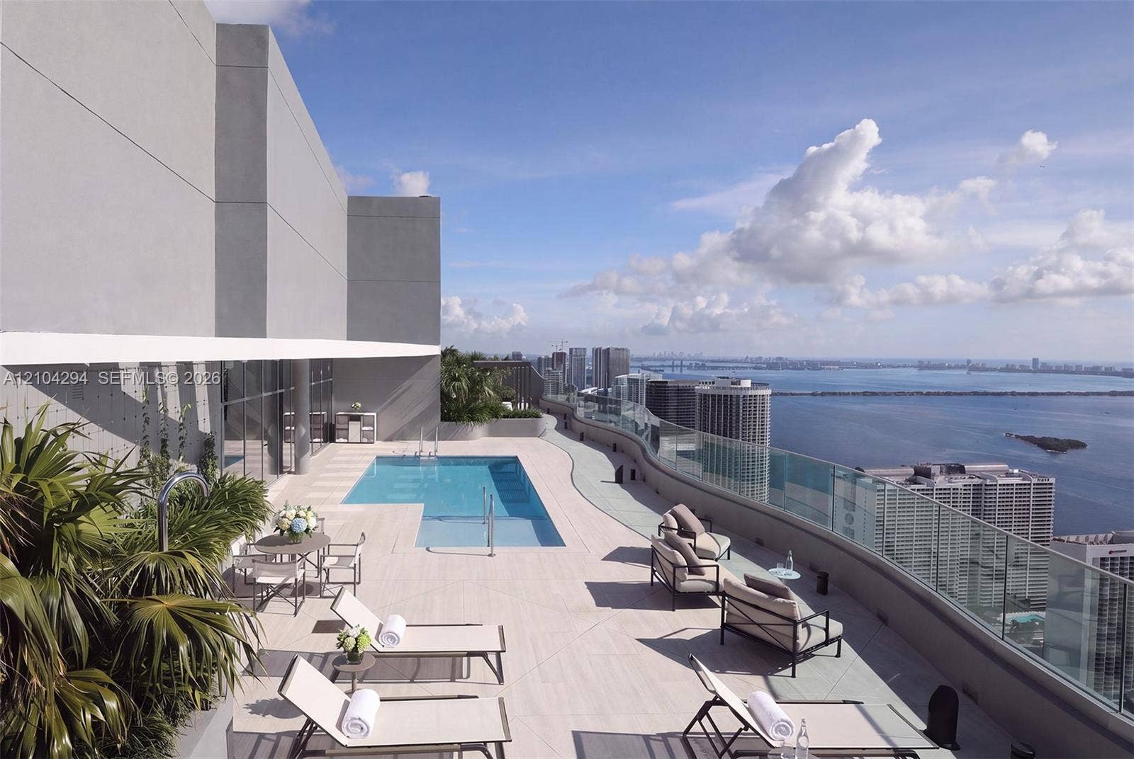 1400 Biscayne Boulevard, #1606, Miami, FL 33132 Elevated terrace featuring a rectangular swimming pool, light-toned paved decking, and a full-length glass perimeter railing