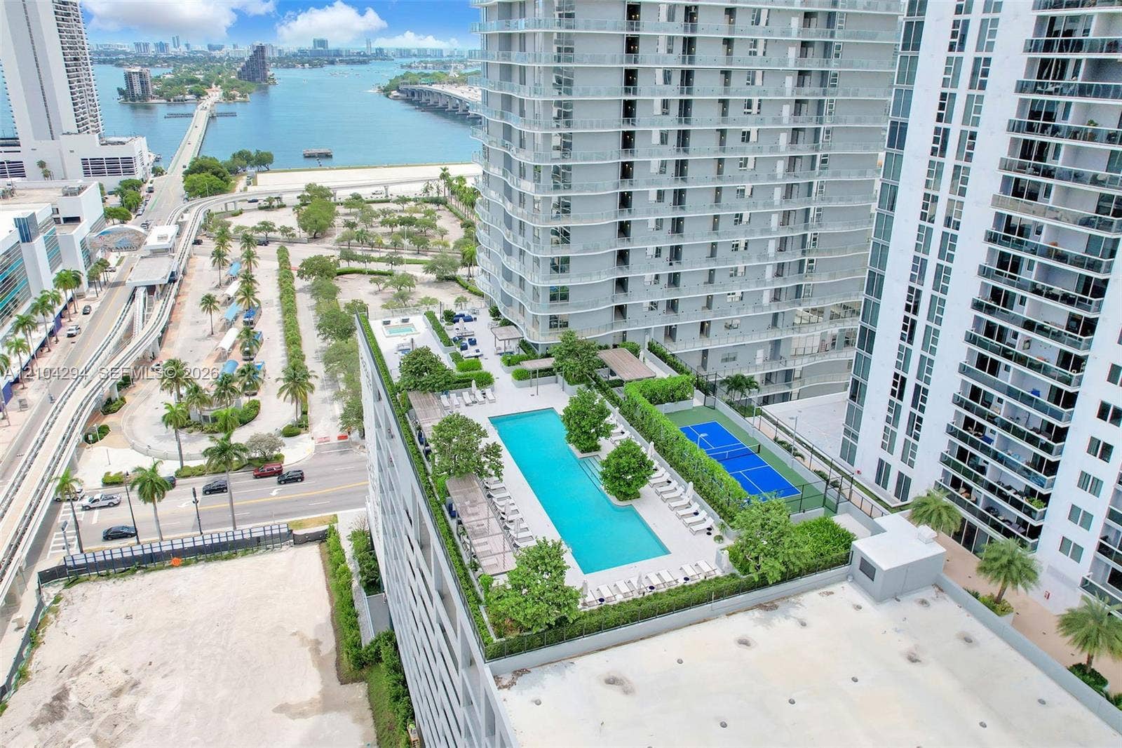 1400 Biscayne Boulevard, #1606, Miami, FL 33132 Rooftop amenities featuring a swimming pool, tennis court, and lush landscaping