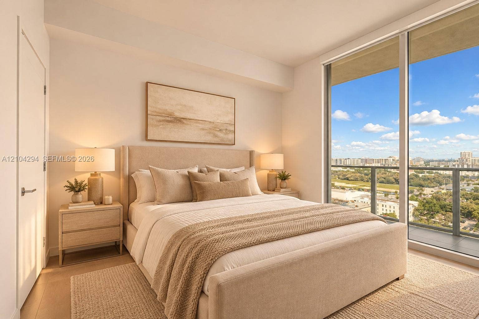 1400 Biscayne Boulevard, #1606, Miami, FL 33132 Floor-to-ceiling glass sliding doors, private balcony with glass railing, light wood-finish flooring, recessed lighting, and a modern interior door