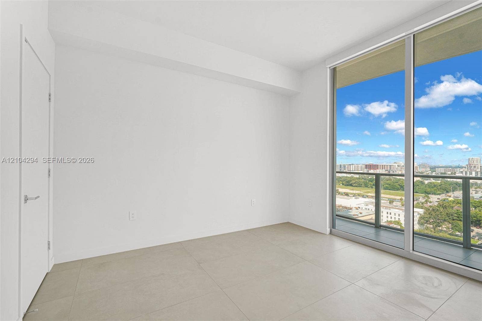 1400 Biscayne Boulevard, #1606, Miami, FL 33132 Expansive sliding glass doors, contemporary tile flooring, and a clean white color palette create a bright, open interior