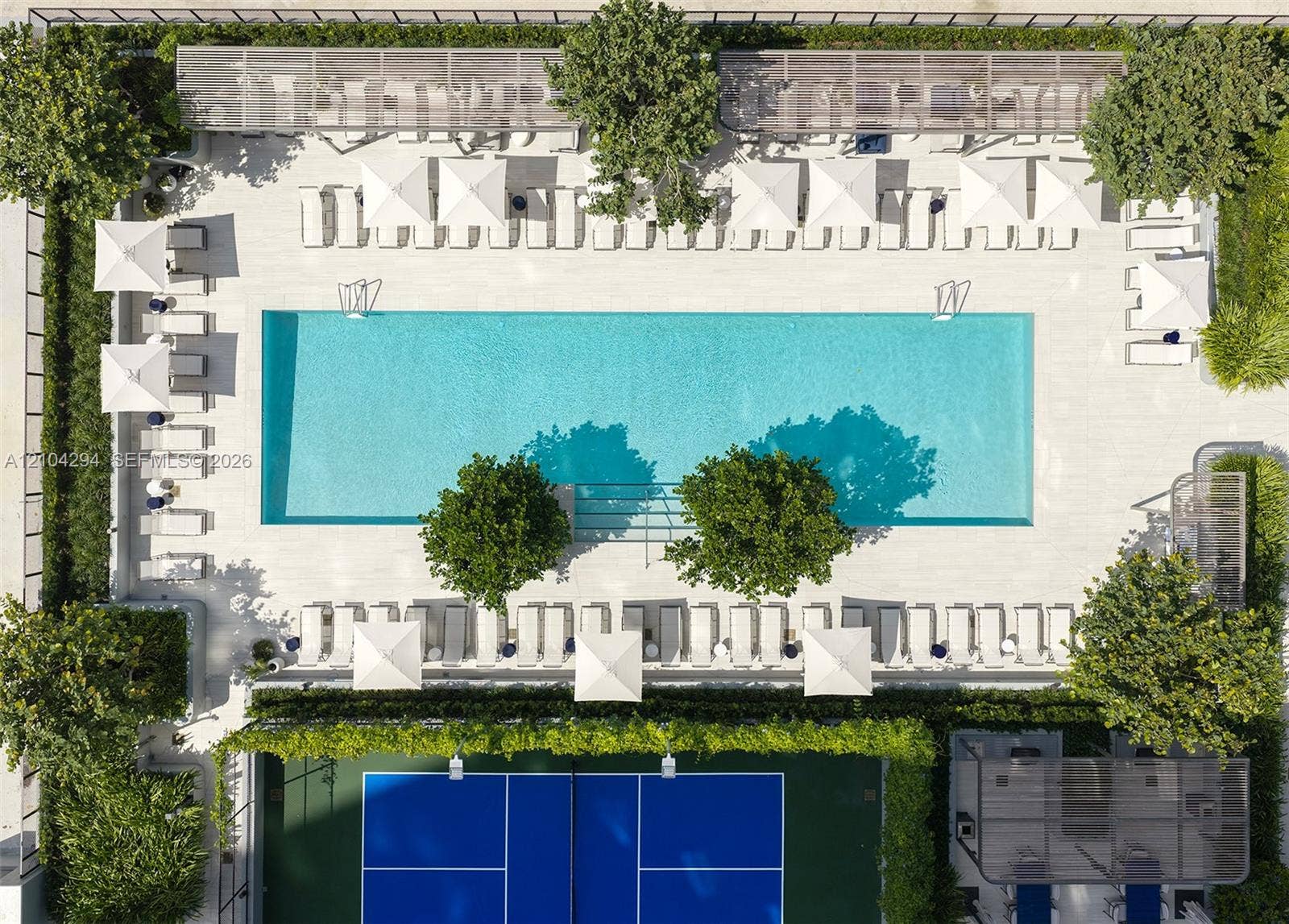 1400 Biscayne Boulevard, #1606, Miami, FL 33132 Rectangular swimming pool with stone-surround decking, enclosed tennis court, integrated metal pergolas, and established perimeter landscaping