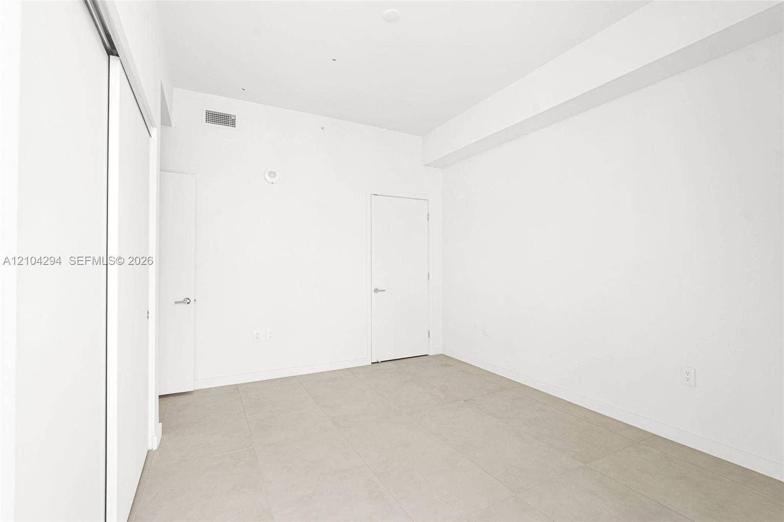 1400 Biscayne Boulevard, #1606, Miami, FL 33132 Neutral white wall finishes, light-toned tile flooring, recessed ceiling lighting, and sliding closet doors